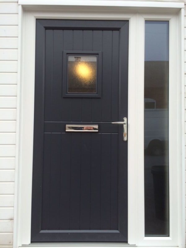 Upvc door with white outer frame and anthracite grey door sash and infill panel: Swipe To View More Images