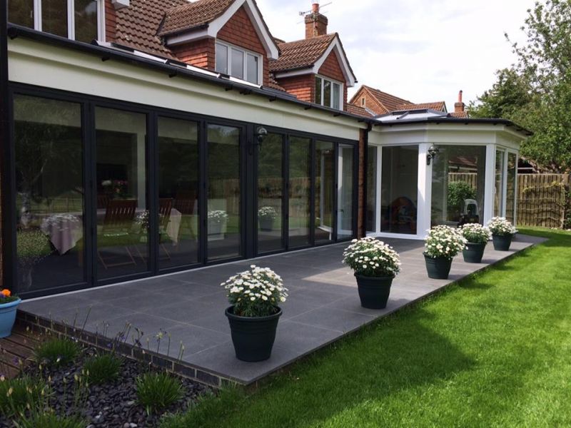 Two anthracite grey Bi Folding doors with a joining pillar.: Swipe To View More Images