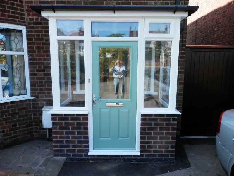 Duck egg blue composite door in a white porch: Swipe To View More Images