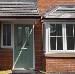 Chartwell green composite door with side flag window. Cruciform Georgian bars to all windows.: Click Here To View Larger Image
