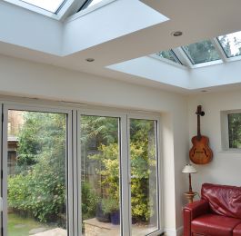 White Bi Fold doors with additional light being added by a duo of roof lanterns: Click Here To View Larger Image