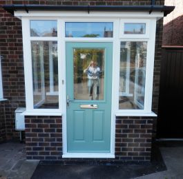 Duck egg blue composite door in a white porch: Click Here To View Larger Image