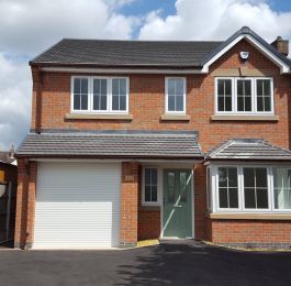 New build with Chartwell green composite door and white windows with cruciform Georgian bars: Click Here To View Larger Image
